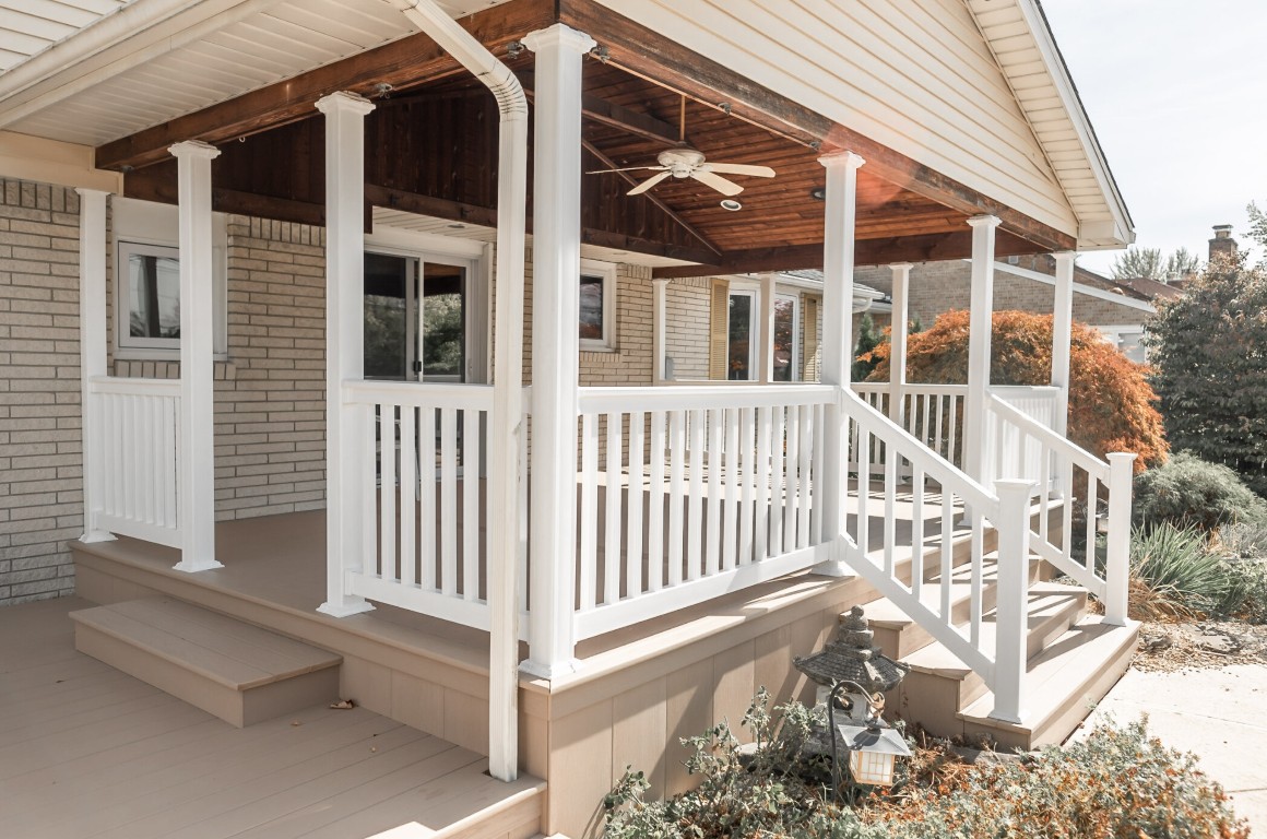 Well-designed deck with designated dining and lounging areas in Irondequoit, NY